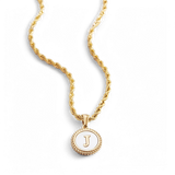 Necklace with a letter on a mother-of-pearl disk on a braided chain