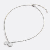 Delicate necklace with a disk bearing initials