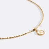 Necklace with a letter on a mother-of-pearl disk on a braided chain