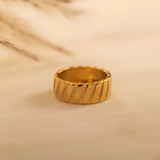 Domed ring with a ribbed texture