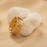 Domed ring with a ribbed texture