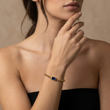 Golden beaded bracelet with a birthstone