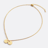 Delicate necklace with a disk bearing initials