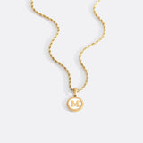 Necklace with a letter on a mother-of-pearl disk on a braided chain