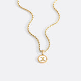 Necklace with a letter on a mother-of-pearl disk on a braided chain