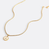 Necklace with a letter on a mother-of-pearl disk on a braided chain