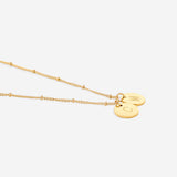 Delicate necklace with a disk bearing initials