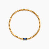 Golden beaded bracelet with a birthstone