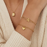 Gold paperclip bracelet with a heart-shaped pendant