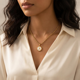 Necklace with a letter on a mother-of-pearl disk on a braided chain