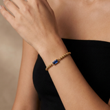 Golden beaded bracelet with a birthstone