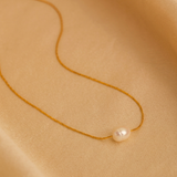 Gold choker with a freshwater pearl